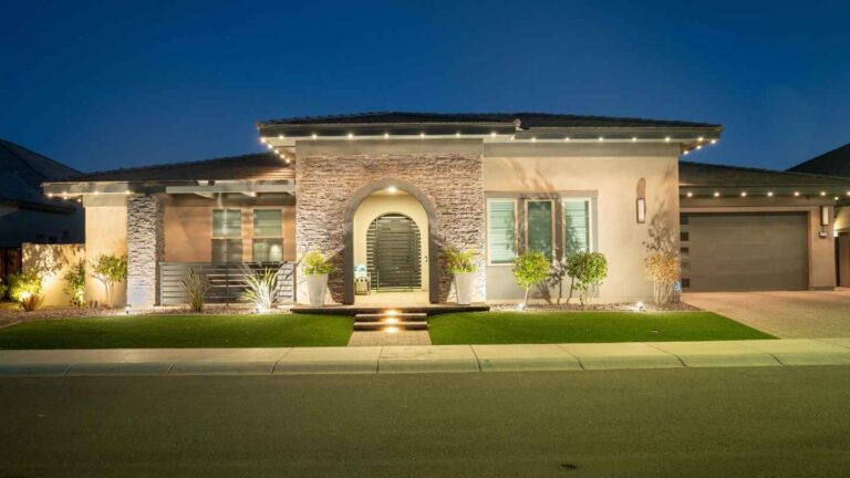 Modern Arizona home glowing with permanent outdoor lighting at night